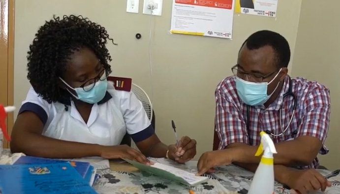 Two doctors wearing facemasks confer at Project ECHO in Namibia