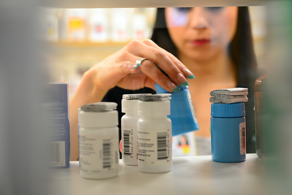 A close-up of pill bottles in a pharmacy.