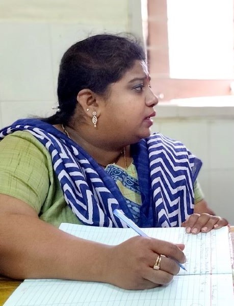 A female Indian health care provider takes notes as she talks to a patient (not pictured)