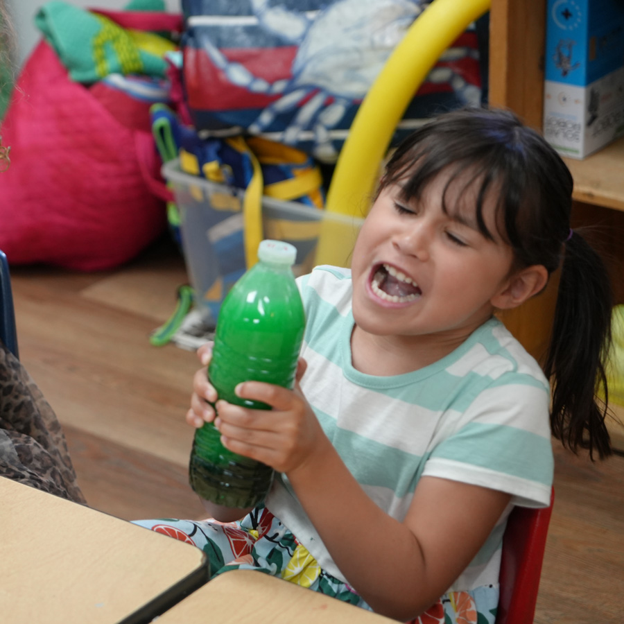 Child shaking bottle.