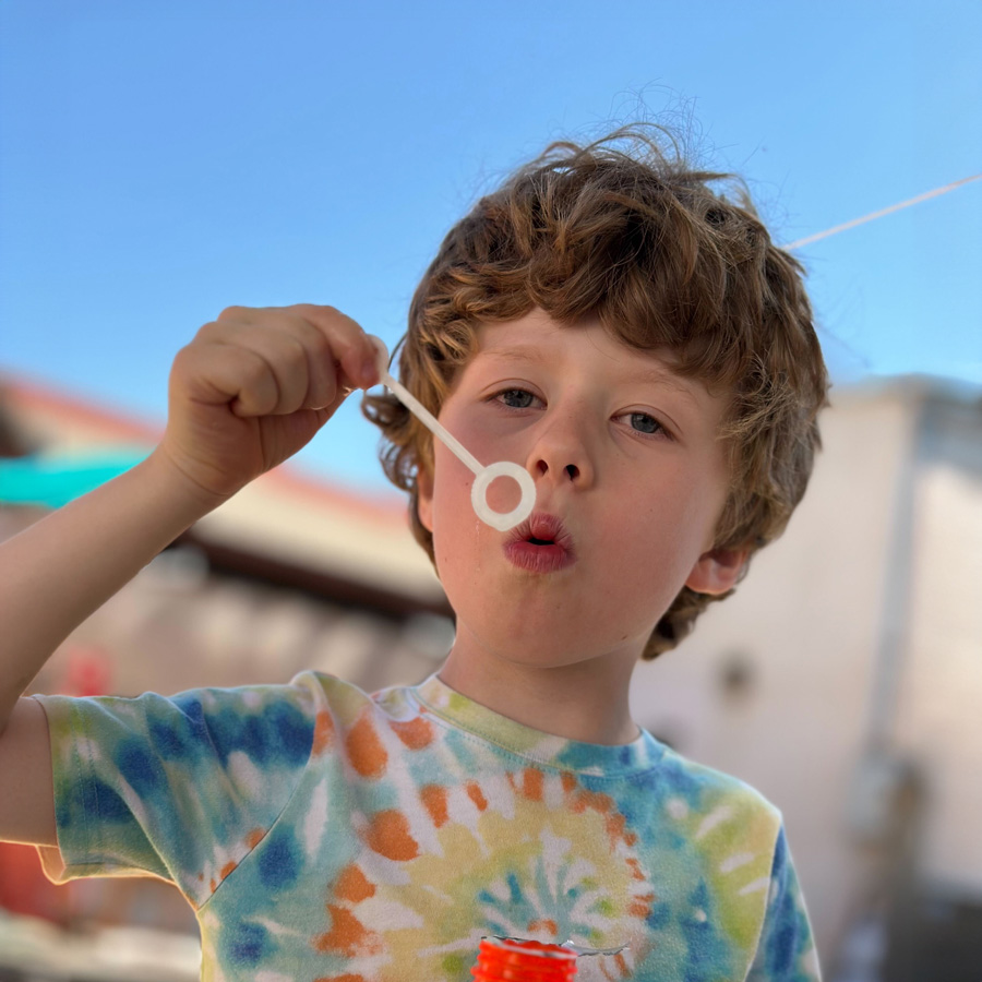 Child blowing bubble.