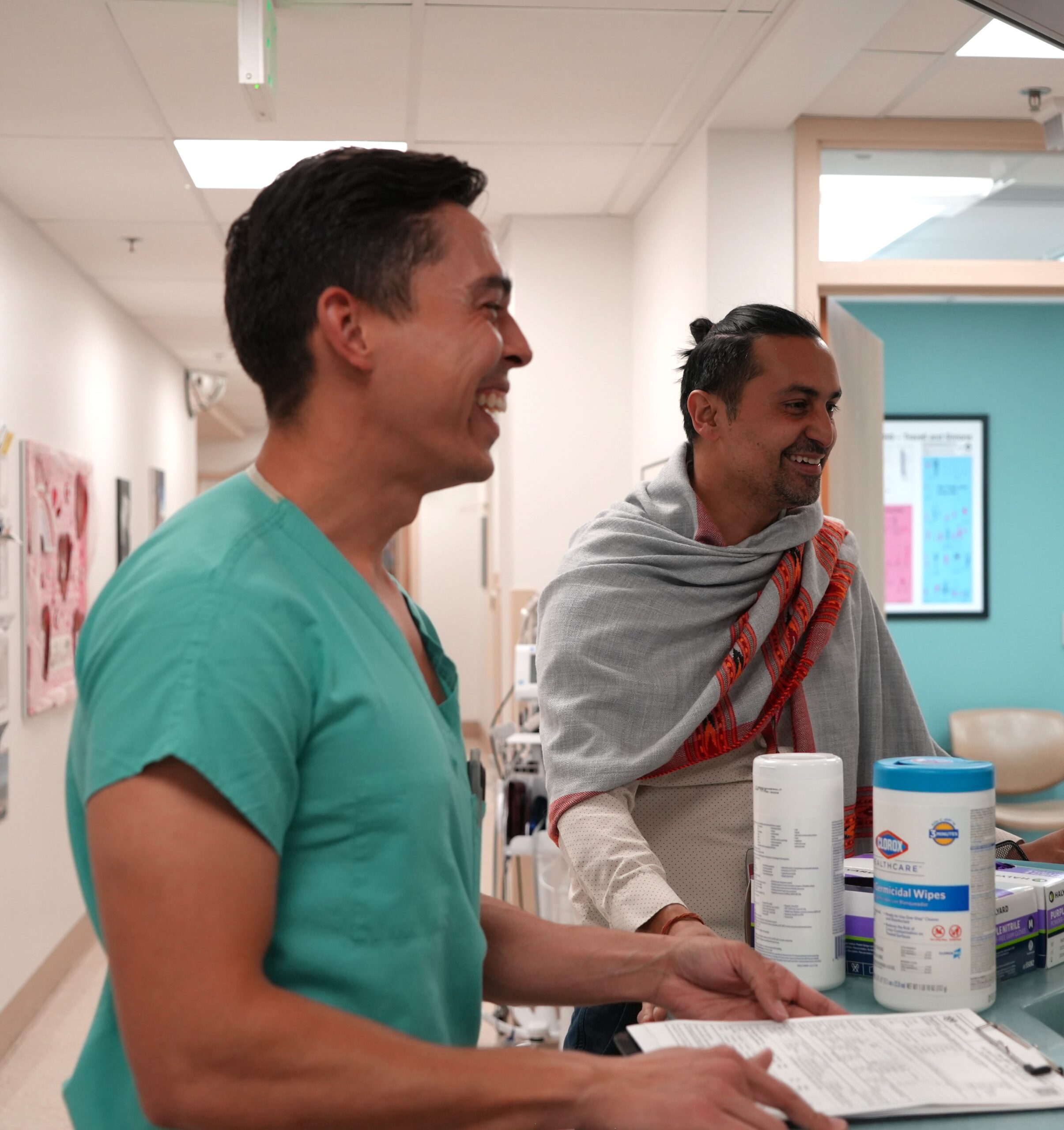 An image of Dr. Krishna Chari standing in his clinic, smiling.