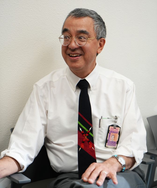 Photo of Dr. Jonathan Iralu sitting against a white wall