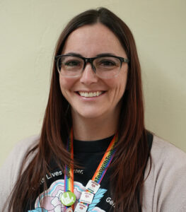 Headshot of Carly Floyd, smiling at the camera