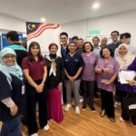 A group of Malaysian health professionals gathered at a National Information Dissemination Centre (Nadi), engaged in an ECHO session.