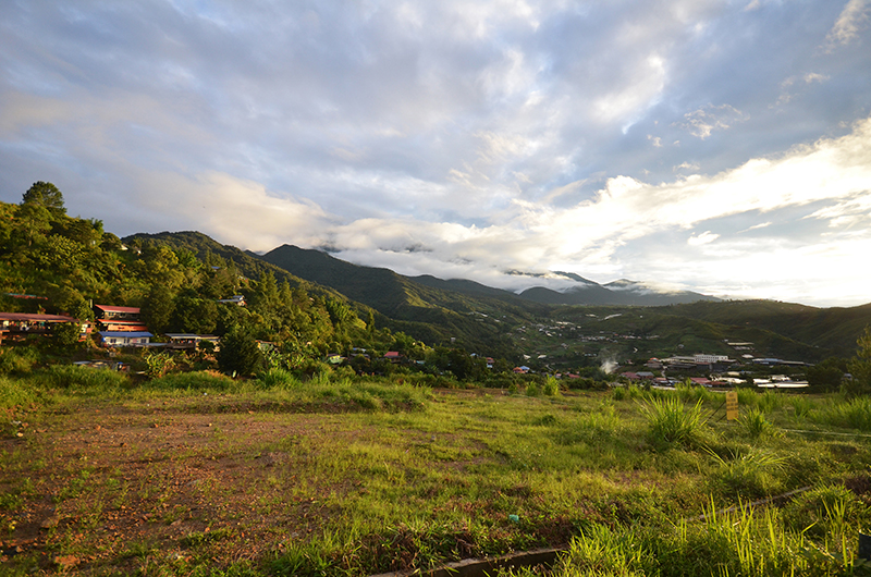 A panoramic view of the rural town of Kundasang in Sabah, East Malaysia, with Mount Kinabalu rising in the background.