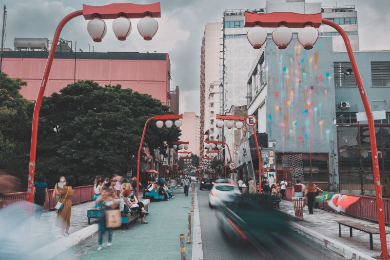 A vibrant and bustling street scene in Bairro da Liberdade, São Paulo, Brazil.