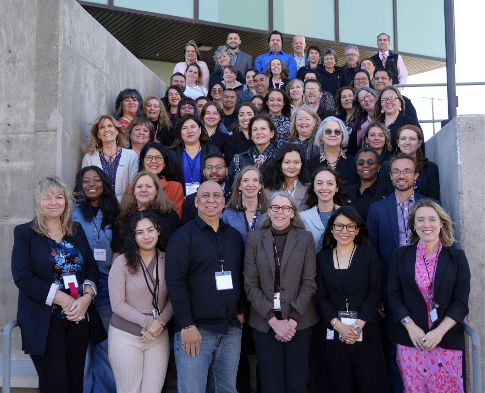 A group of ECHO Staff stand together on stairs at the ECHO Institute building in Albuquerque, New Mexico.