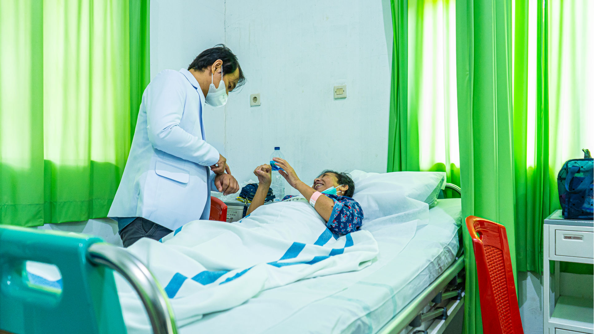 A physician exams a patient in a provincial hospital.
