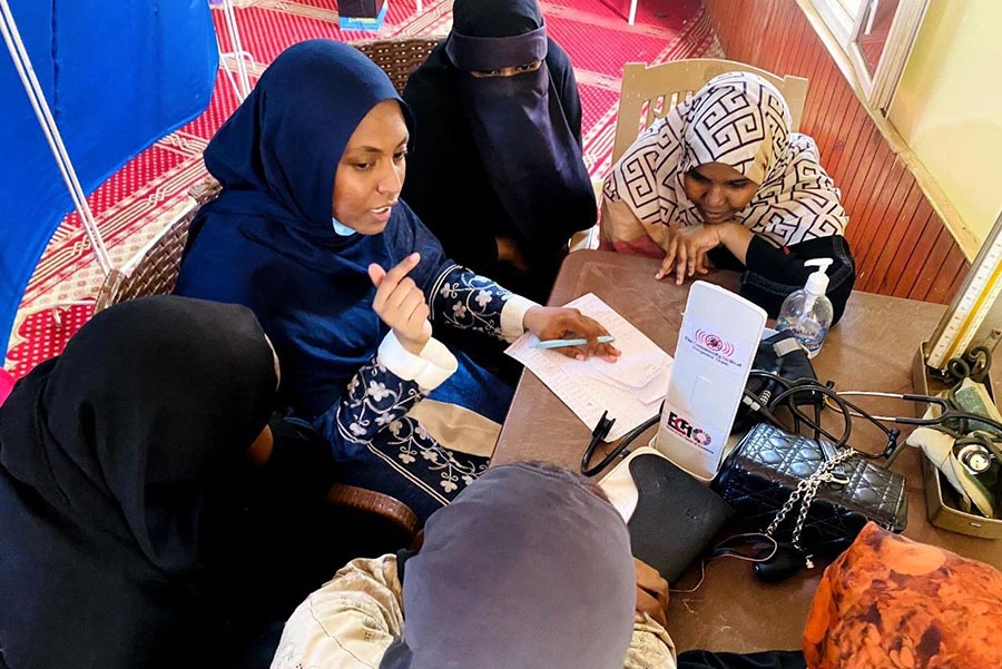 Teacher high-fiving child in classroom.