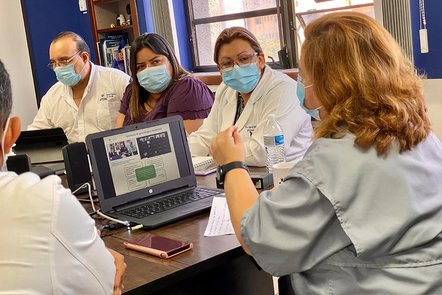 Teacher high-fiving child in classroom.