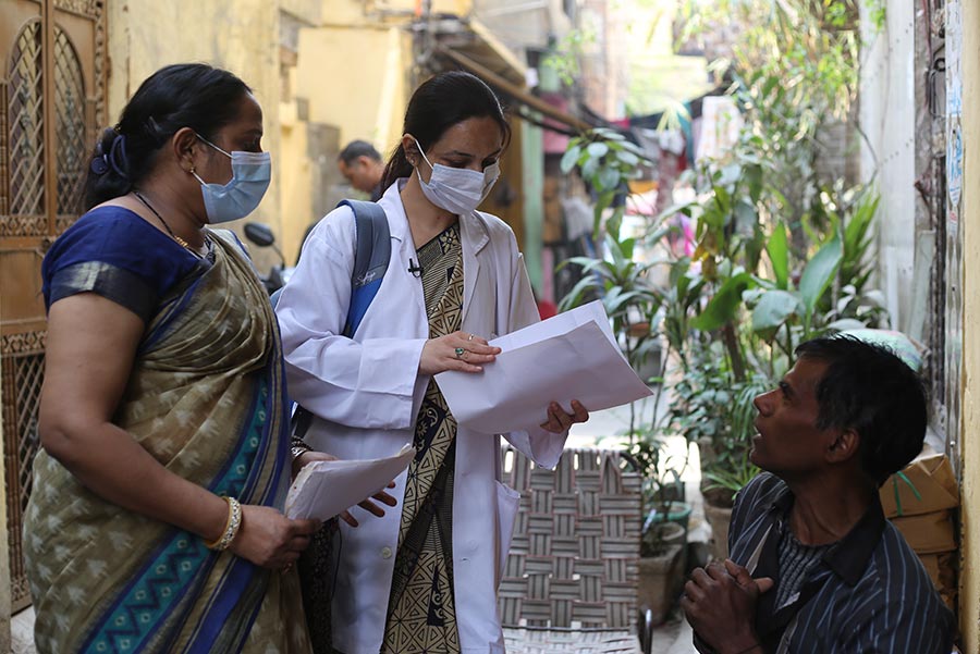 Teacher high-fiving child in classroom.