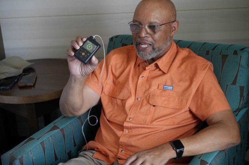 Pastor Ray Beachum of New Mexico holds up his glucose monitoring device.