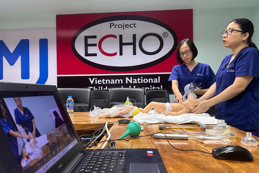 Teacher high-fiving child in classroom.