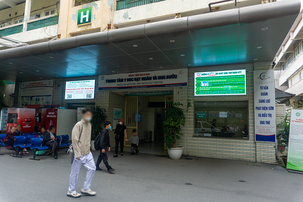 A man walks outside the entrance to the Nuclear Medicine and Oncology Center, Bach Mai Hospital, Vietnam