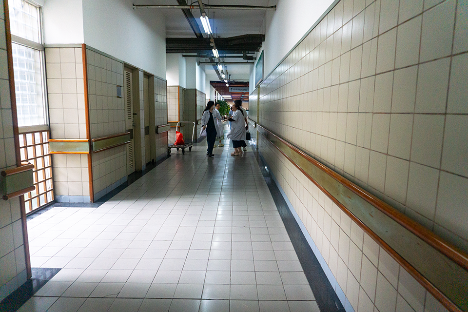 A hallway of the Bach Main Hospital with providers standing at the end