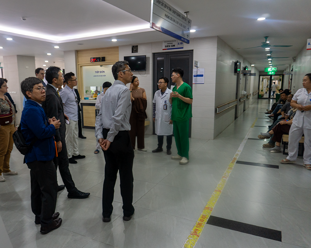 Providers stand in a hallway of the Hanoi Oncology Hospital