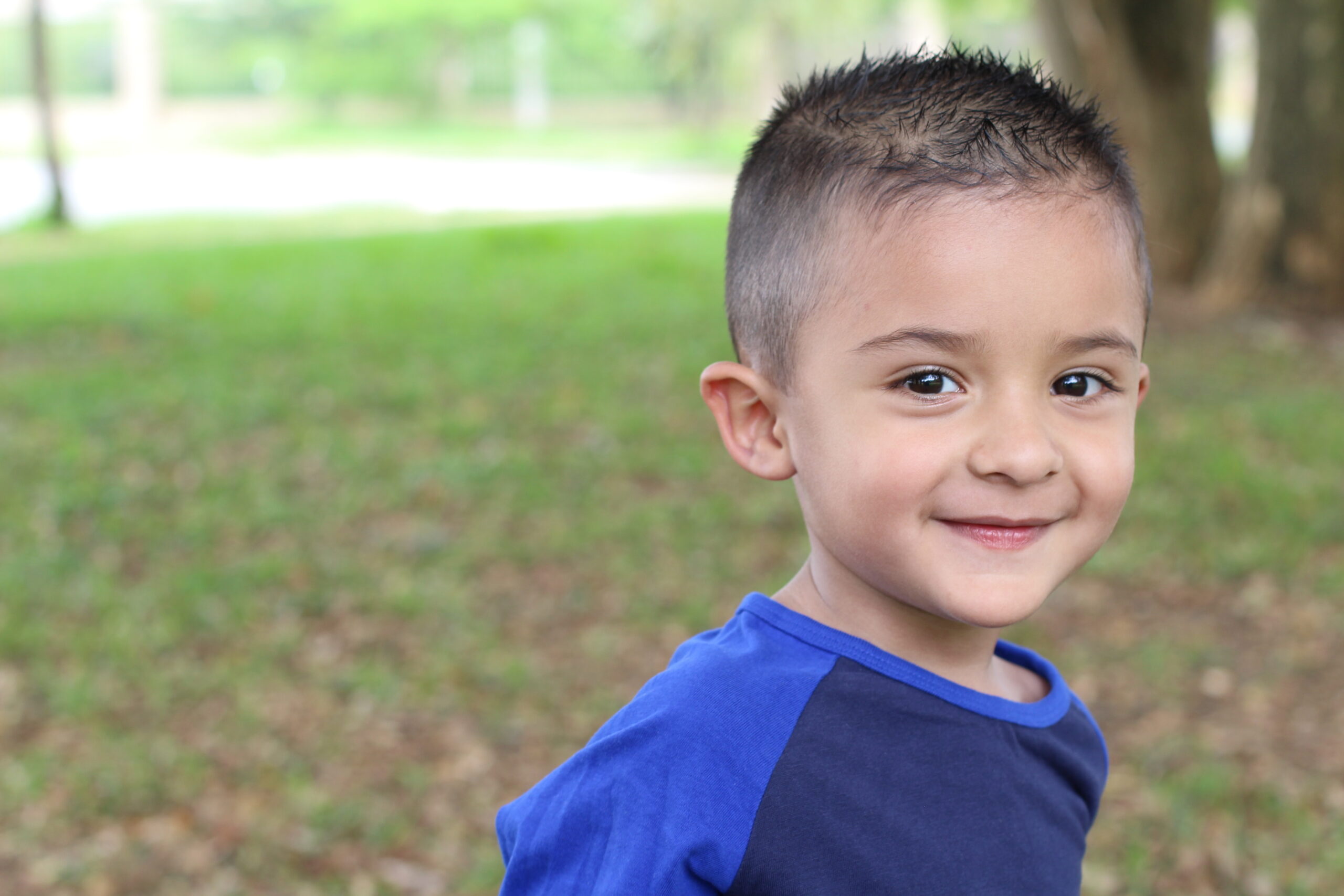A male child smiles at the camera