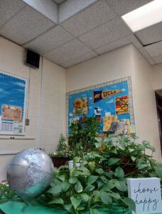 Classroom green corner with plants and activities to help students reset as part of a trauma-informed classroom practice.