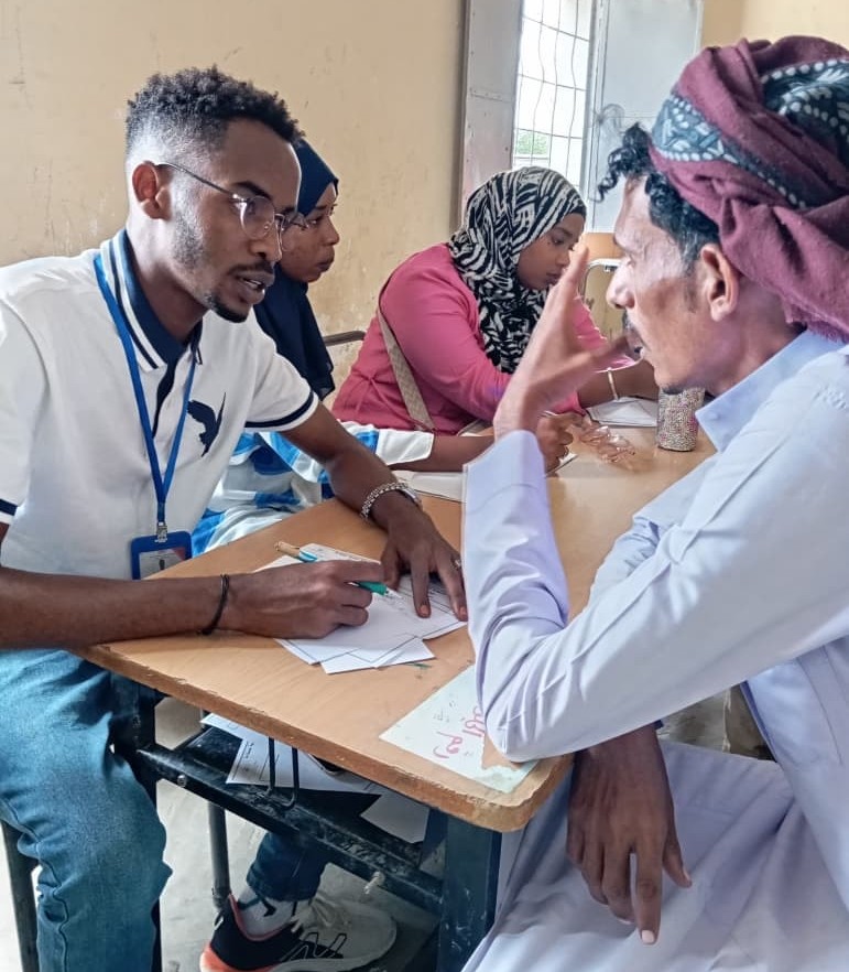 Two men are talking at a ECHO clinic in Sudan