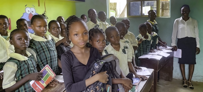 A group of school children stand in their classroom. (Nigeria)